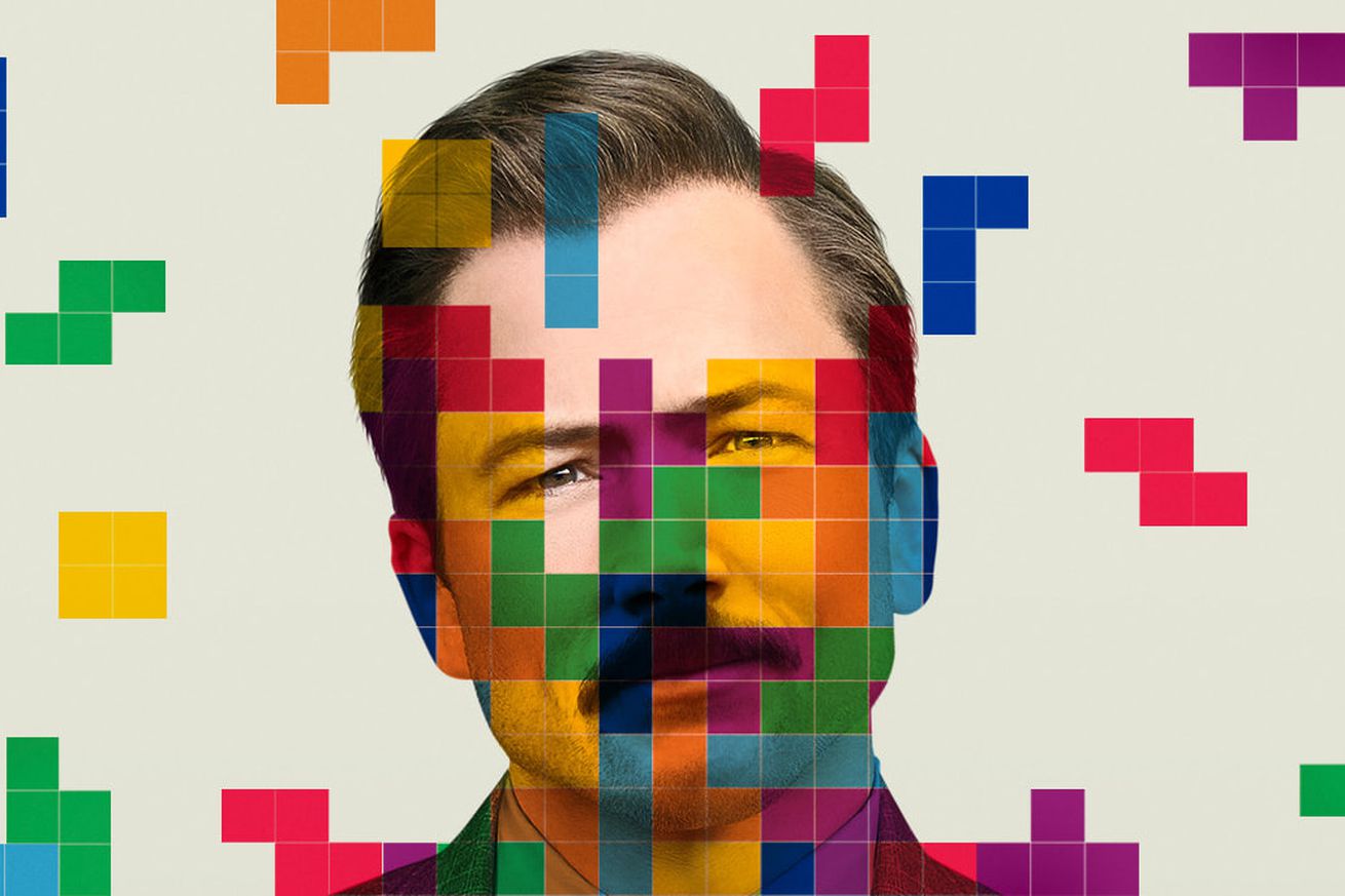 A tight shot of a mustachioed man tilting his head to the side. Overlaid on the image are multiple translucent Tetrominos.